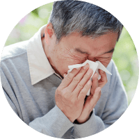 photo of senior man blowing nose